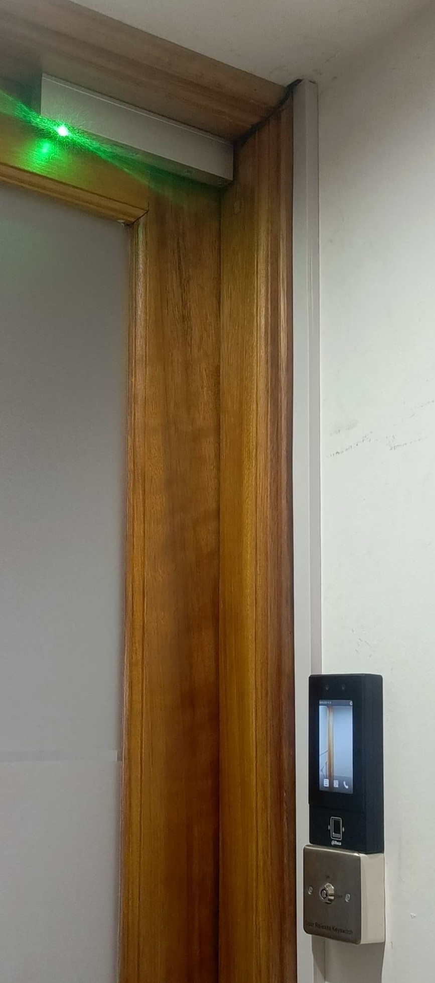 Hikvision facial recognition terminal connected to a magnetic lock (Lighting green on top part of the door)