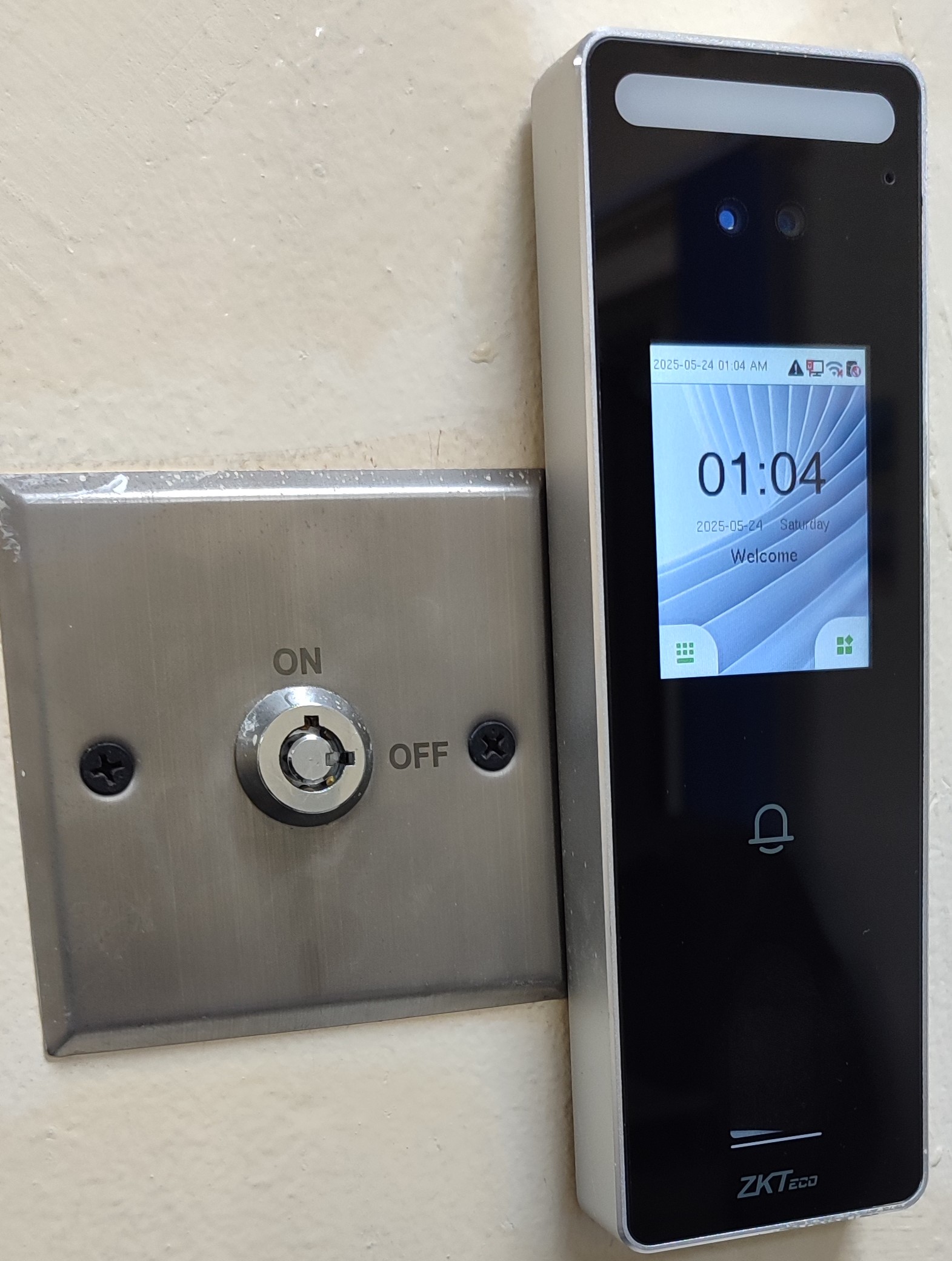 ZKTeco Speedface Biometric device with facial, fingerprint, card and password unlock options. This was installed at Kesses Solar Plant, Eldoret. Alongside it is an emergency override keyswitch.